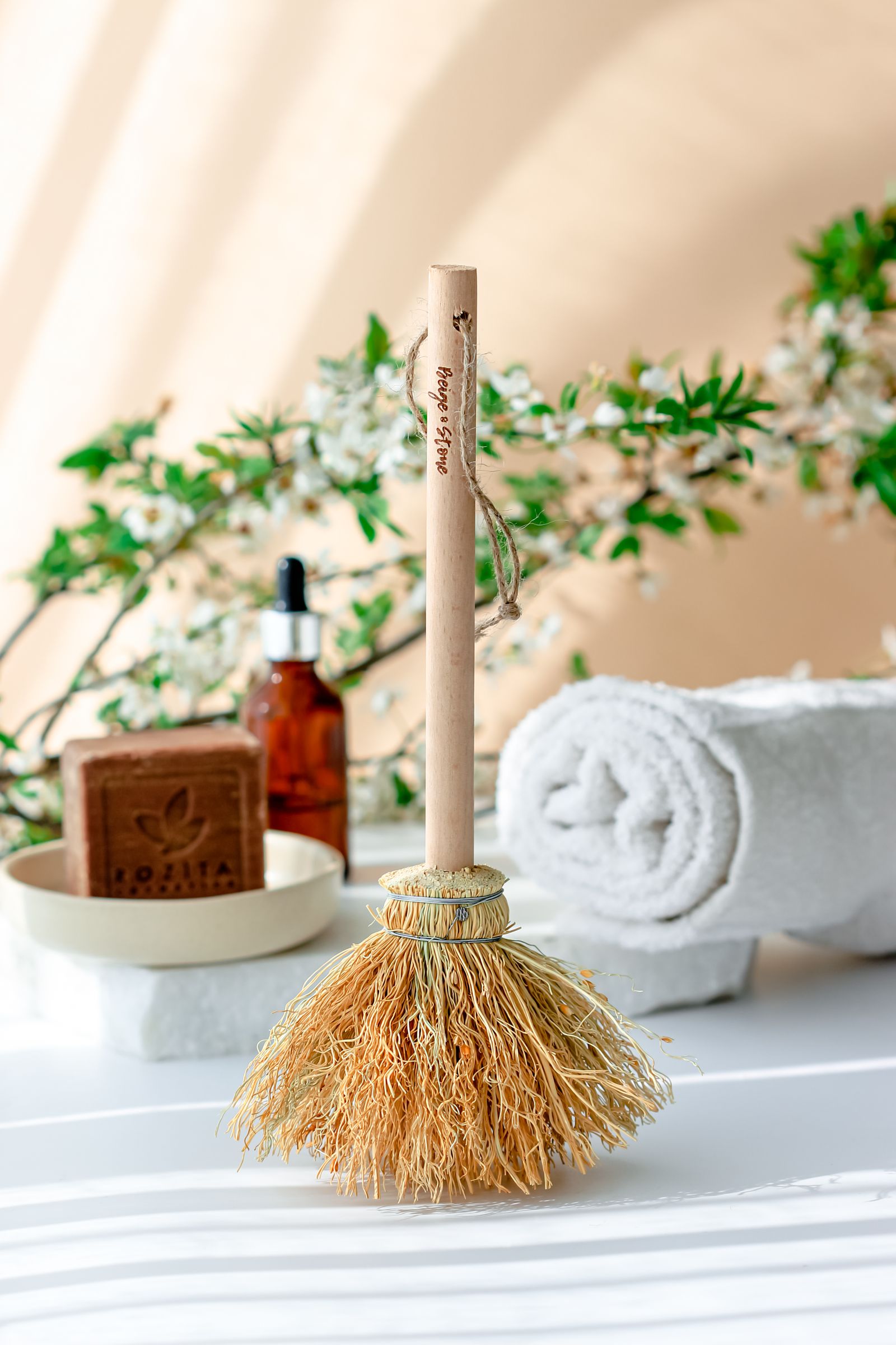 A white towel, body brush and spa care products
