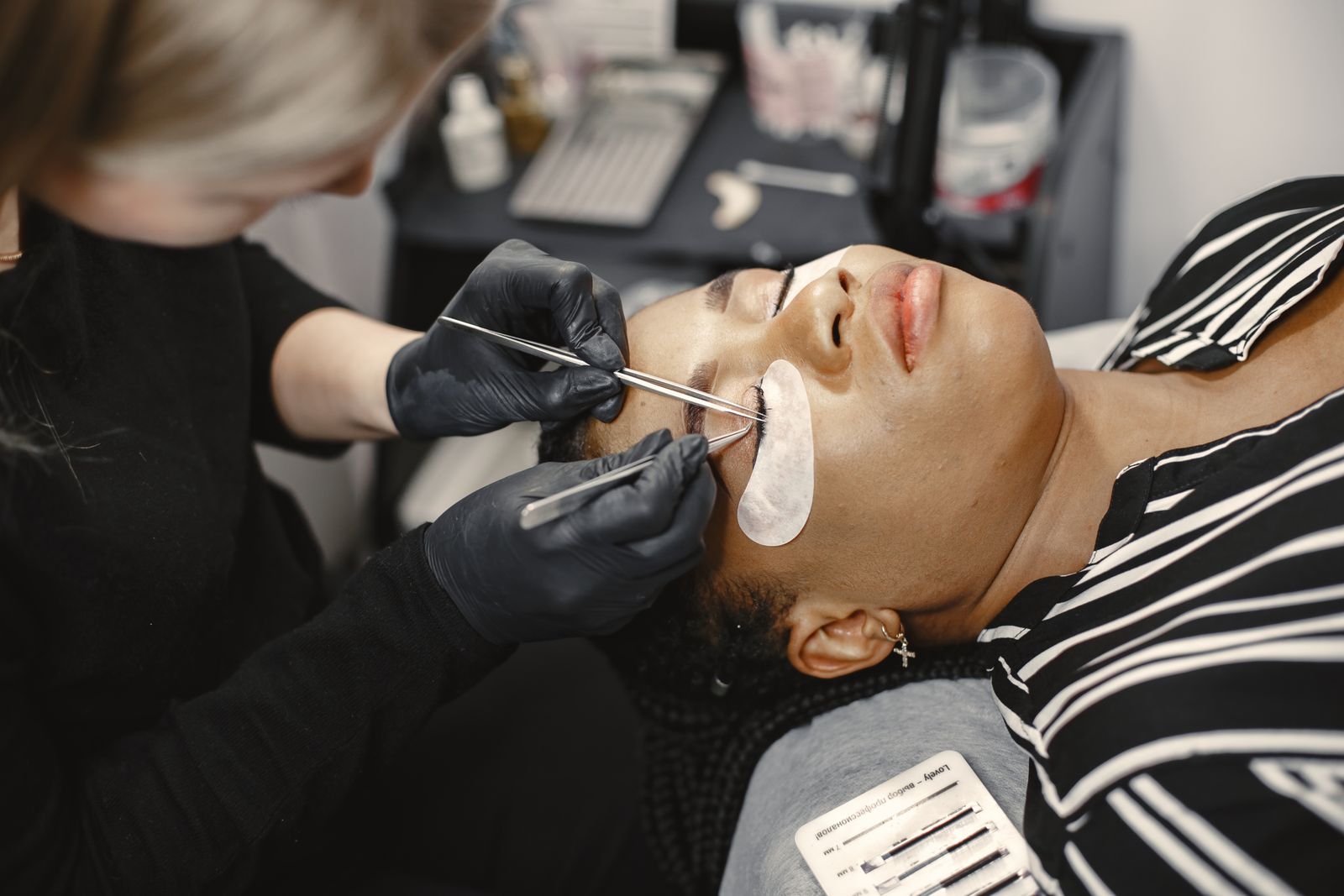 Illustrative close-up of lash extension application