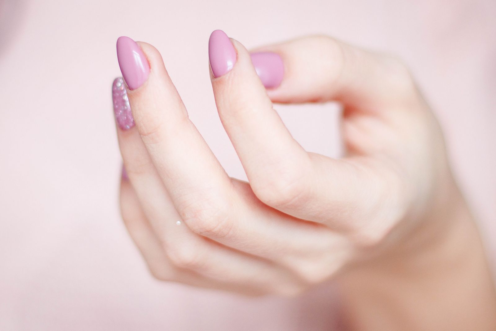 Soft pink manicure with a glitter accent nail