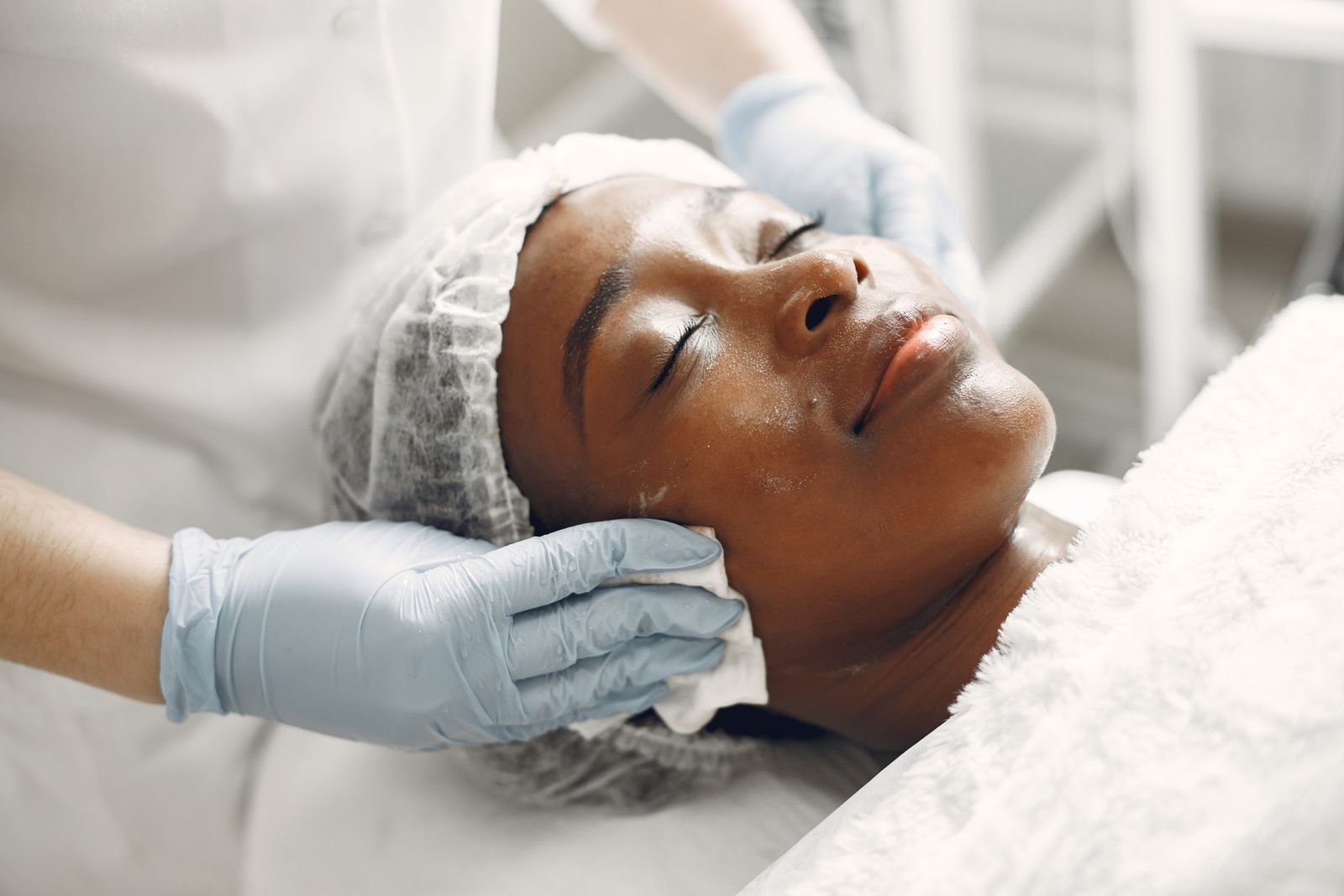 A woman receiving a professional facial treatment
